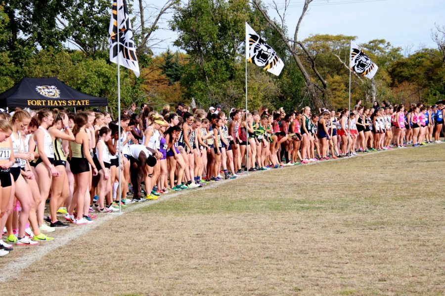 Runners, start your shoes: All the runners stand at the start before the womens race in Victoria, Kan. 17 schools competed in the meet on Oct. 9, 2021.