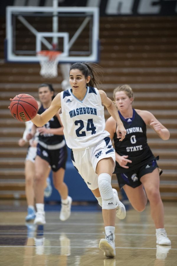 Washburn guard Nuria Barrientos (24) dribbles down the court Friday, Nov. 26, 2021, at Lee Arena in Topeka, Kan. Barrientos scored four points in the game.