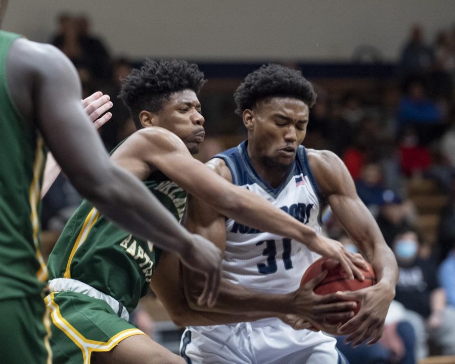 Washburn forward Kevaughn Ellis (right) grabs the rebound against Oklahoma Baptist guard Jaquan Simms (left) Tuesday, Nov. 23, 2021. The game was held at Lee Arena in Topeka, Kansas.