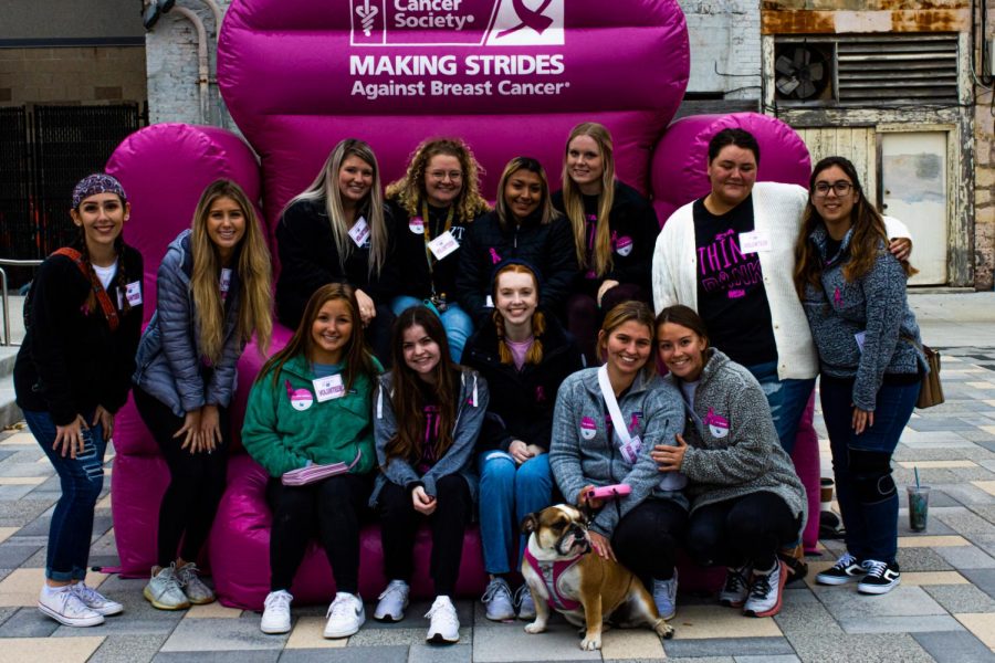Everyone+in%3A+ZTA+chapter+students+get+their+photo+taken+at+the+Making+Strides+Against+Breast+Cancer+event+with+Olive+the+dog+on+Oct.+23%2C+2021.