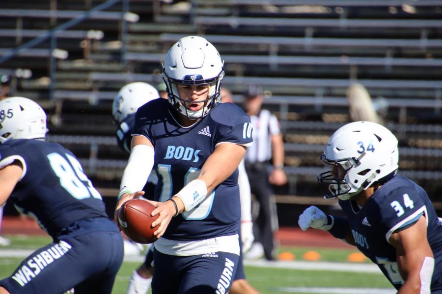 Handoff%3A+Washburn+quarterback+Kellen+Simoncic+%2810%29+hands+off+the+ball+on+Oct.+30%2C+2021.+Simoncic+finished+the+game+with+131+passing+yards.