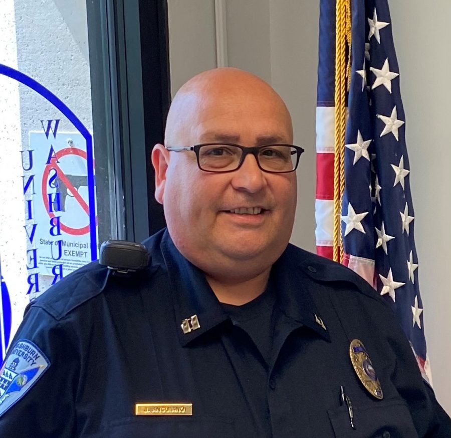 Back on duty: Captain James Anguiano smiles for a picture near the front door of the Washburn University Police Department. Anguiano joined WUPD in 2021 after working for KUs Public Safety Office for thirty years.