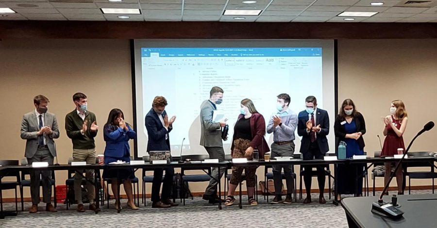 Send Off: Dylan Babcock (center left) retires from his position as WSGA vice-president with one final gavel. Everyone attending took to their feet and applauded him as he took a seat in the gallery at the meeting Dec. 1, 2021.
