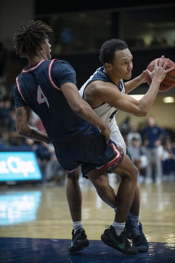 Washburn guard Isaiah Thorne (right) is fouled by Rogers State guard Gerren Jackson (left) Saturday, Dec. 18, 2021, at Washburn University in Topeka, Kan. Thorne played seven minutes in the Ichabods 70-69 win.
