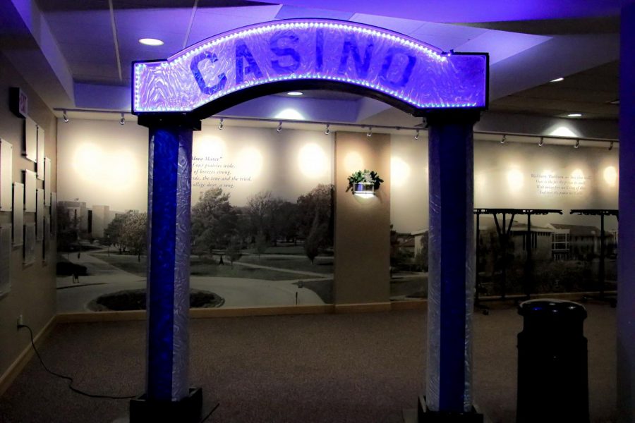 A lit up sign telling you this way to Casino Night event and also to take pictures by. This was shot at Casino Night in Washburn Memorial Union on December 8th, 2021.