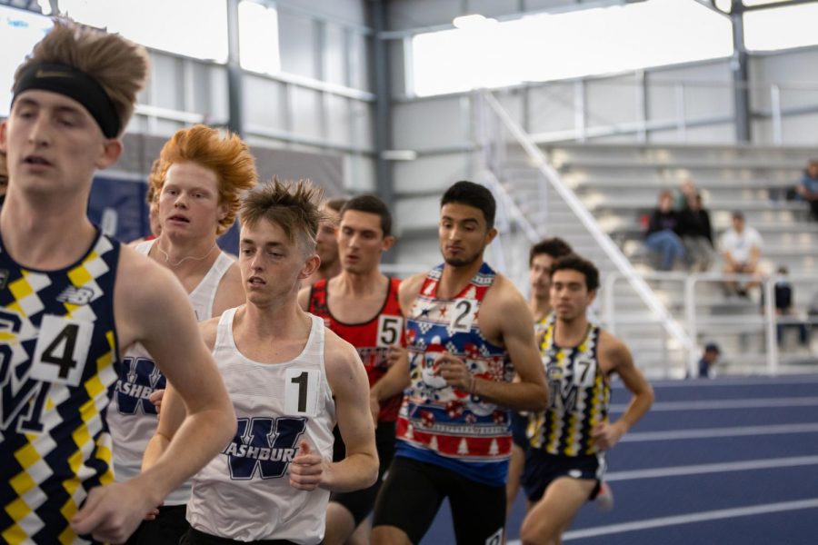 Quinn Buessing (WU left) and Nathan Gray (WU right) run amongst the other competitors. The Washburn Alumni Invitational took place on Dec. 4, 2021.