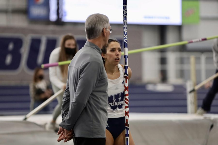 Washburn athlete communicates with coach after her jump on Jan 22, 2022, Topeka, Kan.