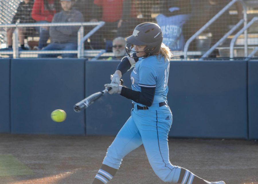 Jaycee Ginter (12) swings at the ball Feb. 20, 2022. Ginter scored one run in game one of the teams doubleheader.