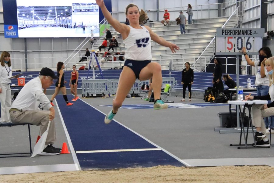 Sophomore Taylor Grasser jumps in the long jump event Feb. 10, 2022. Grasser finished with a top distance of 5.07 meters.