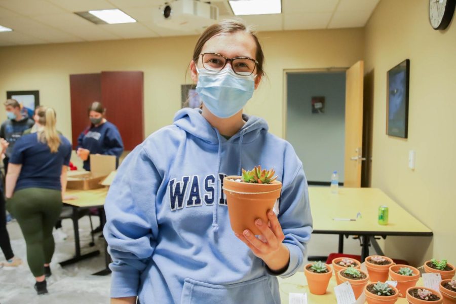 Kari Edelman, a freshman business major, displays her finished succulent pot. Edelman enjoyed the new activity.