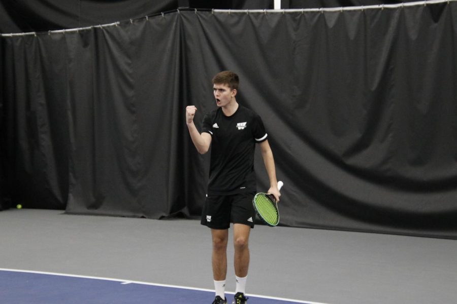 Freshman Tim Hammes celebrates after winning a point Feb. 19, 2022. Hammes won his singles match in two sets.