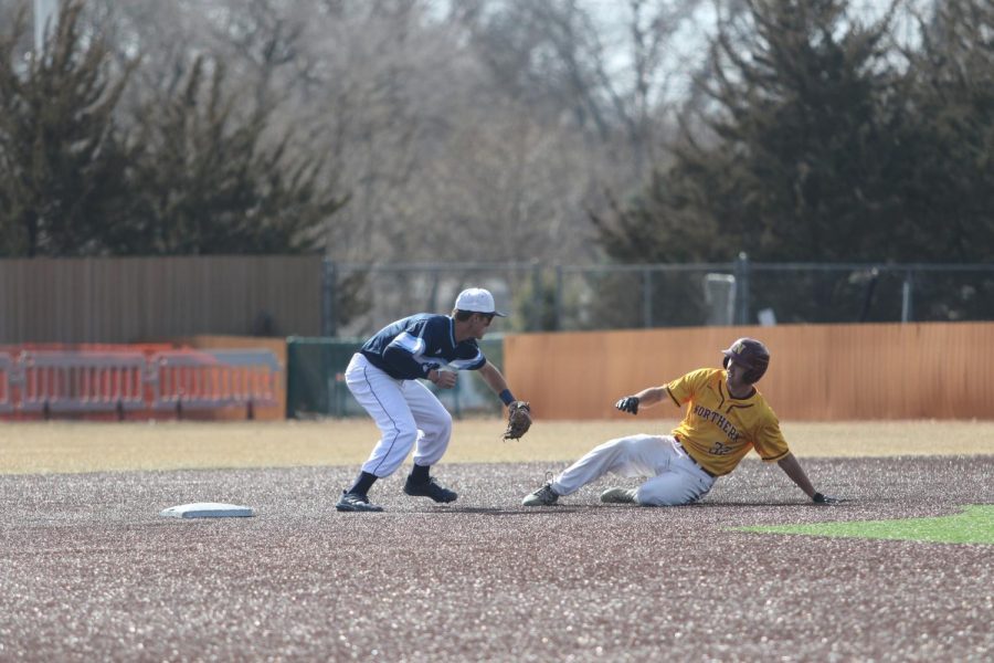 Sophomore Otto Jones tags out a base stealer Feb. 21, 2022. Jones recorded three putouts in the game.