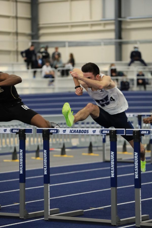 Washburn sophomore Romain Henry runs in the 60-meter hurdles Jan 29, 2022, Topeka, KS. Henry finished with a time of 8.19 seconds in the preliminaries.