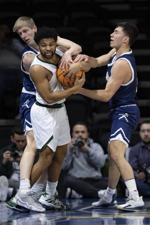 Washburn guard Michael Keegan (left) and guard Tyler Geiman (right) reach for the ball Sunday, Mar. 6, 2022, at Municipal Auditorium in Kansas City, Missouri. Washburn fell to Northwest Missouri State 84-76 in the game.