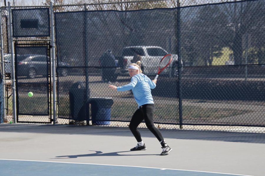 Freshman Lara Schmid returns a ball Mar. 25, 2022. Schmid fell in her singles match in three sets playing from the fourth position.