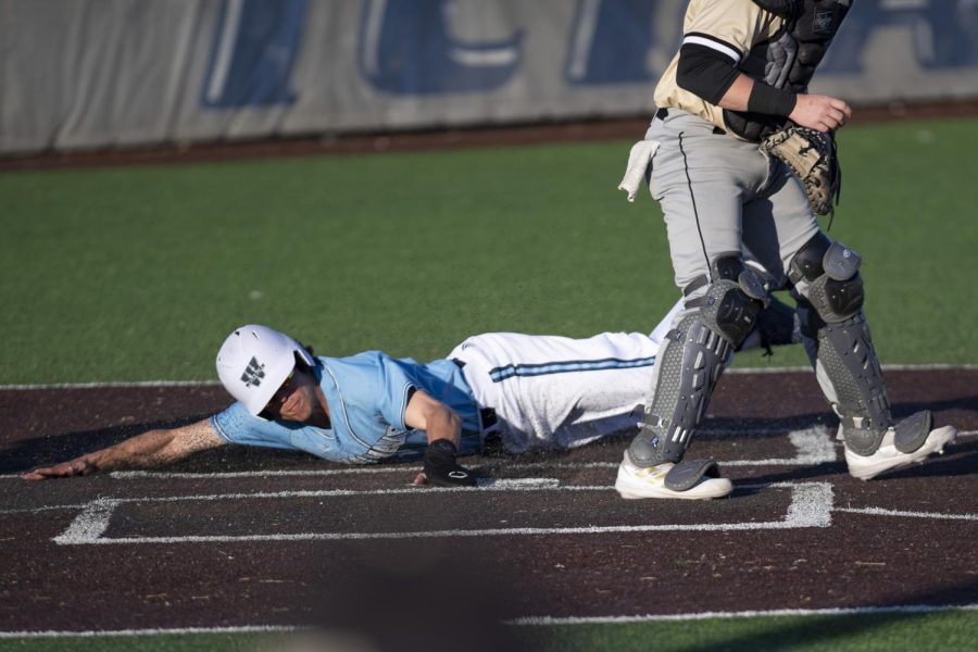 Washburn outfielder Connor Scott (2) slides to home plate Tuesday March. 1, 2022, at Washburn University in Topeka, Kansas.