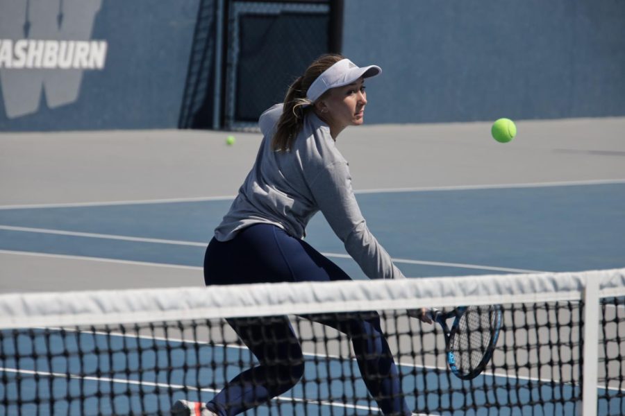 Cadence Lynn hits the ball near the net Mar. 26, 2022, Topeka, Kan. Lynn won her singles match in three sets playing from the sixth position.