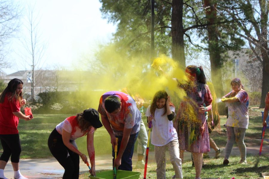 Students fill up on water and throw colored powder at the Holi Festival. The Holi Festival was held on Saturday, March 26.