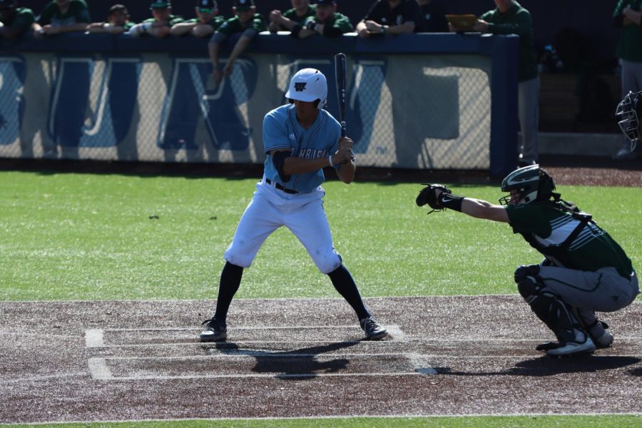 Cal Watkins (1) begins to swing the bat Mar. 15, 2022, Topeka, Kansas. Watkins scored one run in the game.