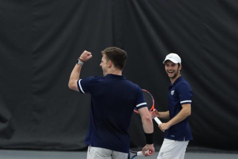 Senior Miller Zeiders (left) and sophomore Daniel Bird (right) celebrate after winning a point April 21, 2022. Zeiders and Bird won their No. 3 doubles match 6-3.