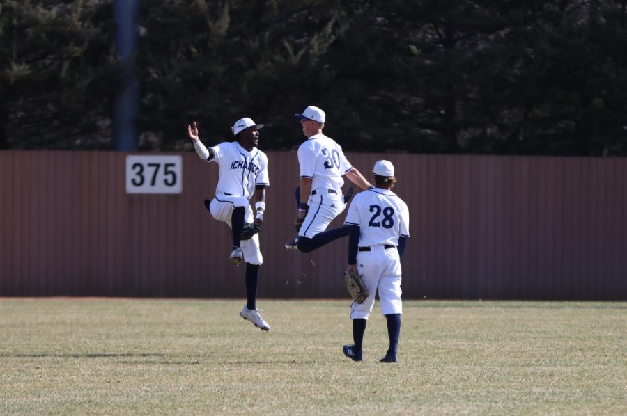 Sophomore Seger Holman (30) and junior Shane Morrow (left) celebrate after the game Mar. 26, 2022. Washburn defeated Missouri Western State 13-5 in the game.