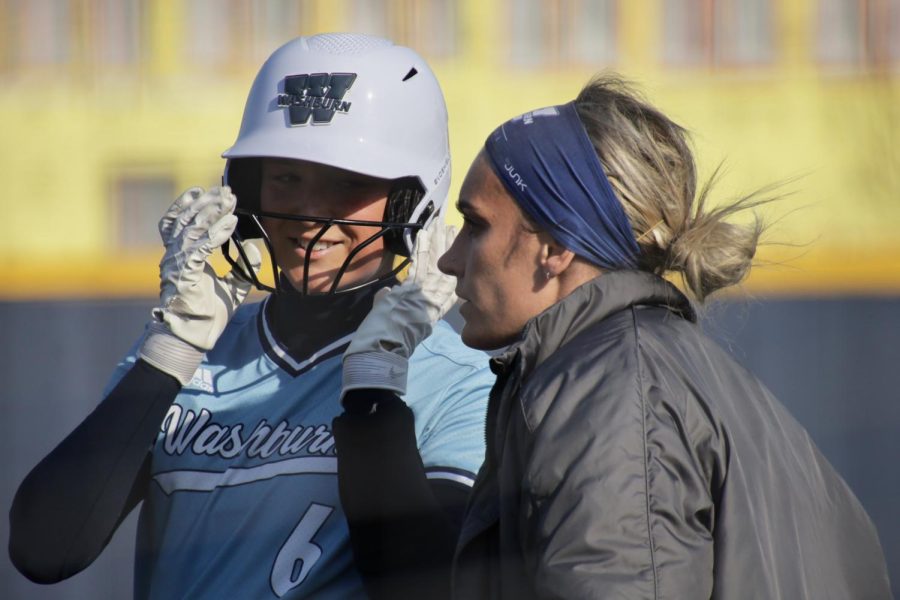 Washburn junior Hardely Kerschen (6) talks to assistant coach Taylor Zordel April 15, 2022, Topeka, Kansas. Kerschen scored one run in game one of the day.