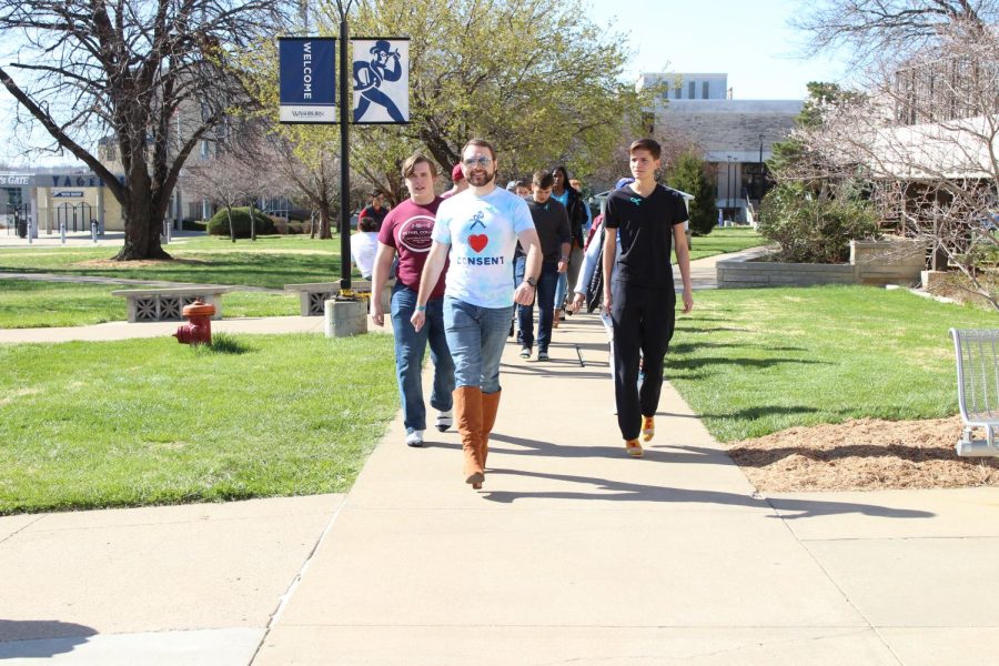 Participants finish their second lap around the Eastern Union Lawn.  WSGA hosted the Walk a Mile in Her Shoes event April 9, 2022.