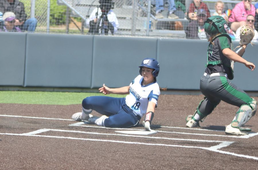 Freshman Jaden LaBarge slides into home April 24, 2022. LaBarge scored two runs in game one of the day.