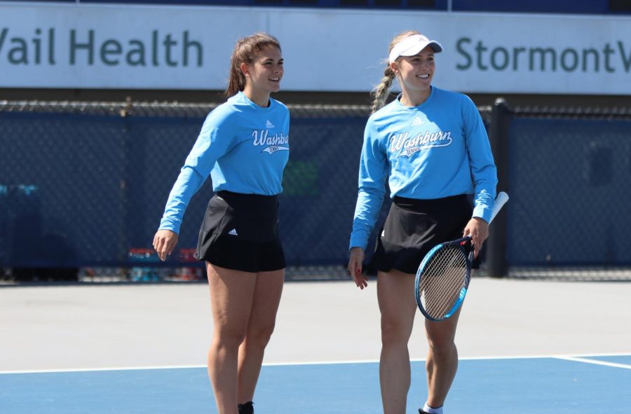 Sophomore Marta Torres (left) and senior Svea Crohn (right) smile after a point April 24, 2022. Torres and Crohn won their No. 3 doubles match 6-4.