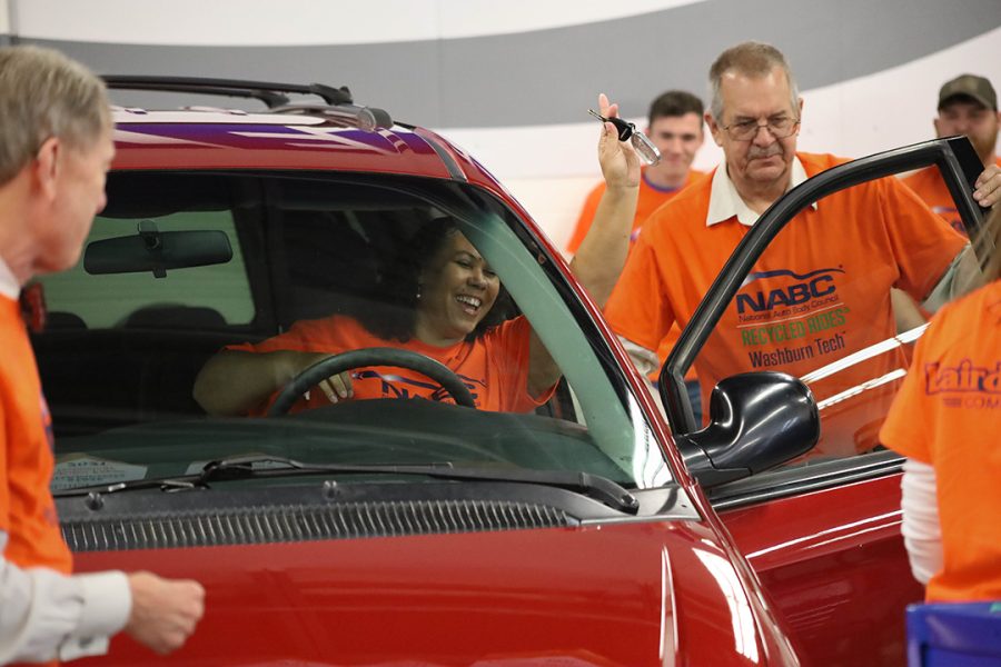 Cheilese Thomas flashes her new key. Thomas has had her fair share of vehicle troubles prior to receiving the 2007 Chrysler Town & Country.