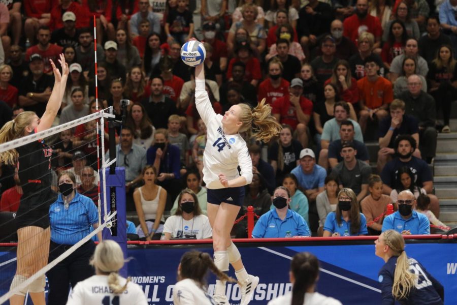 Kelsey Gordon goes up against a block and makes contact with the ball. Gordon served as co-president of the Student Athlete Advisory Council at Washburn in 2021.