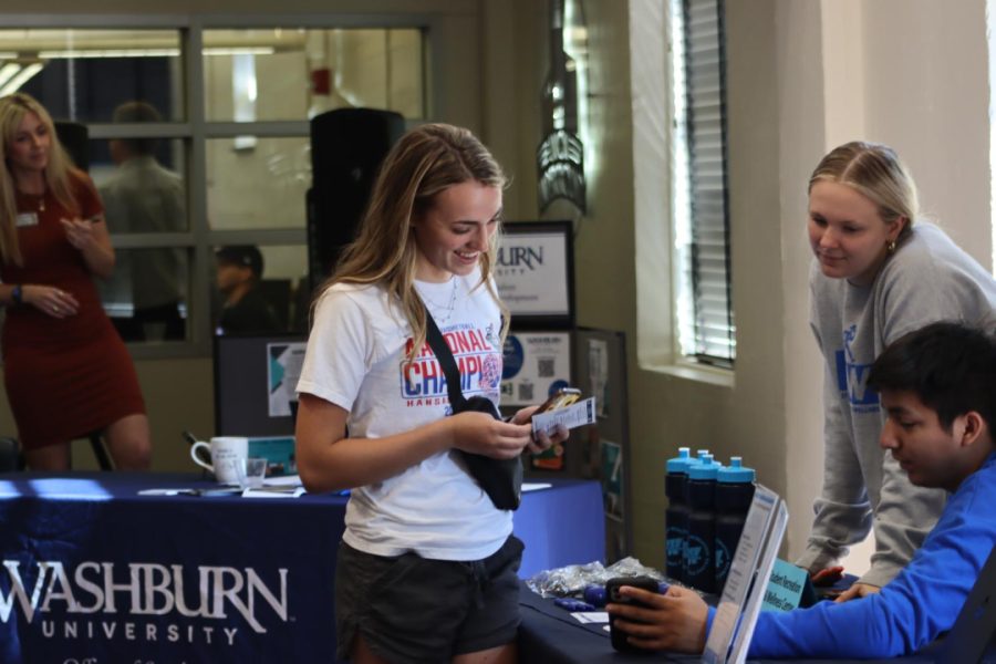 Sophomore Gracen Lesher stops by the table for the Student Recreation and Wellness Center. Office workers were there to provide students with the information they need to consider job offers.