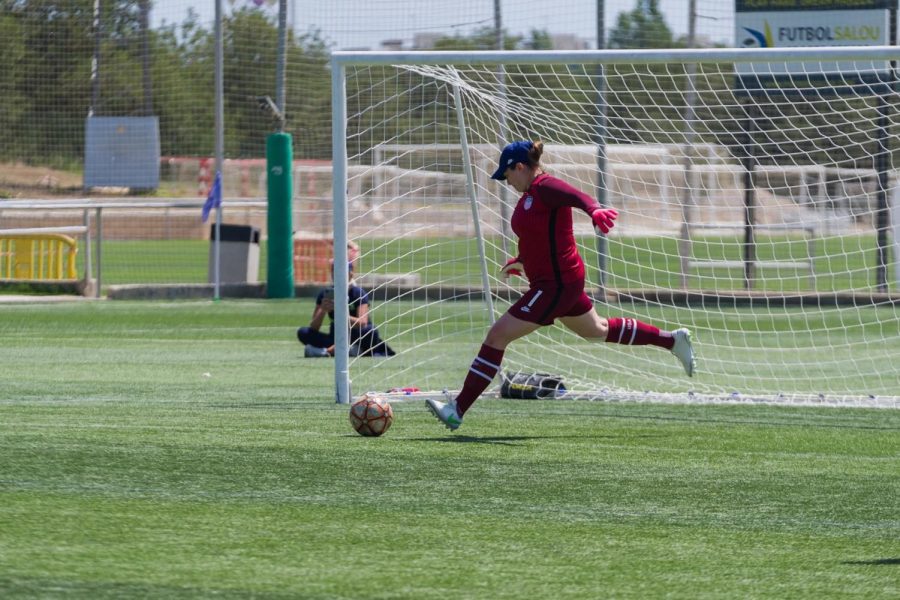Emily Lauritsen kicks a ball away from the goal during a match. Emily participated in the IFCPF World Cup in May 2022.