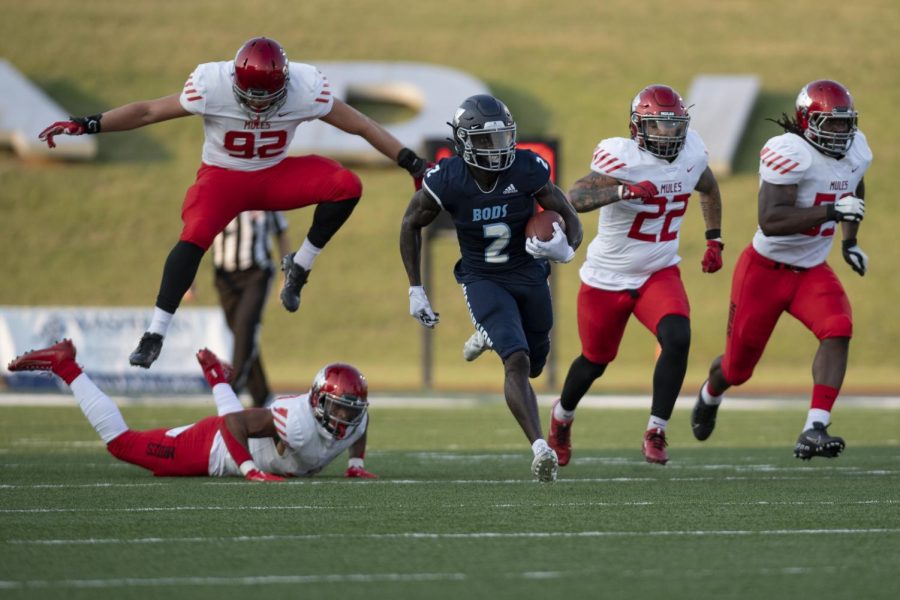 Peter Afful avoids Central Missouri defense in a fall 2021 game at Washburn. Football players can face higher risk of mental health issues such as depression and aggression.