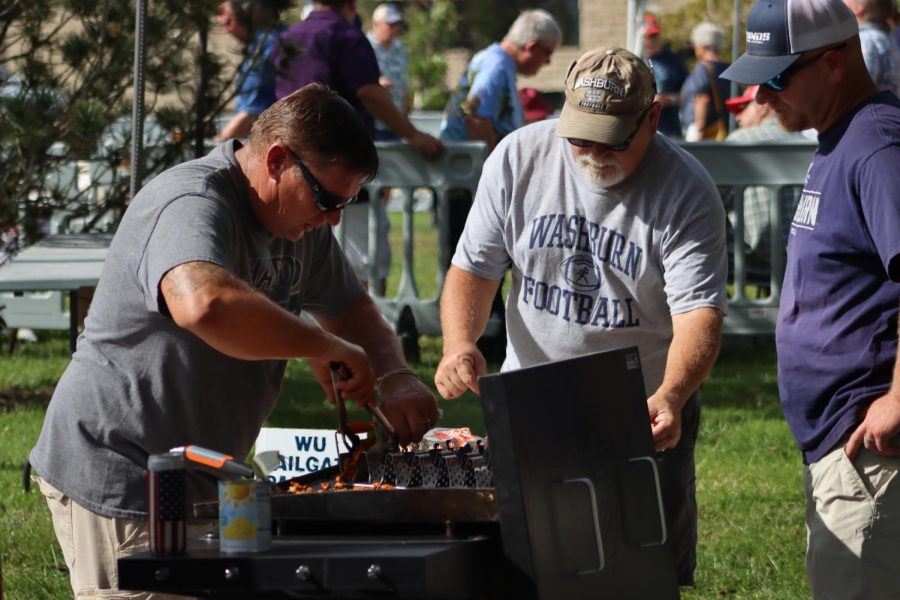 Kelly Urban, Pat Bruner, and Eric Rokey grill up food for their tailgate attendees. Urban, Bruner and Rokey are the fathers of football players Landen Urban, Grant Bruner, and Cauy Rokey, respectively.