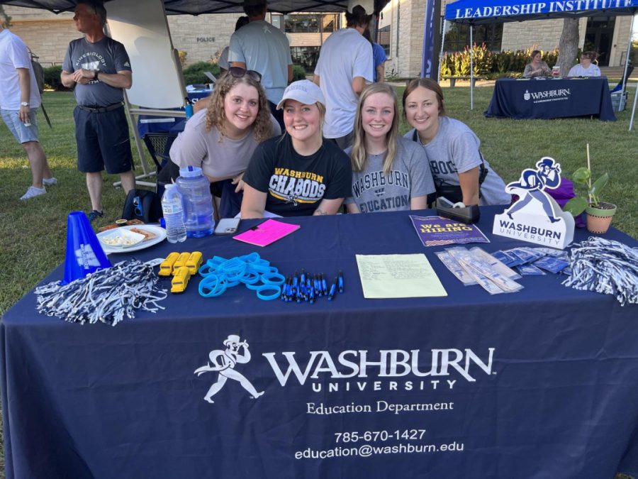 Washburn Education Department attended WUFest to give information about scholarships, trips, and connections. Megan Scoot, junior in elementary education, Baylee Blaufuss, major in elementary education and special education, Kayley Taylor, junior in education, and Megan Kohn, major in education, pose for a picture at their WUFest table.