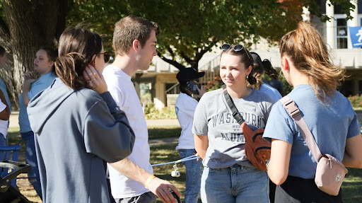 Alumnus Claire Leffingwell, Kensey Kuttler, senior in kinesiology, and junior biology majors Mary Tyler and Bryce Liedtke gather to talk. The tailgate was a great opportunity for people to hang out with old friends and make new ones.
