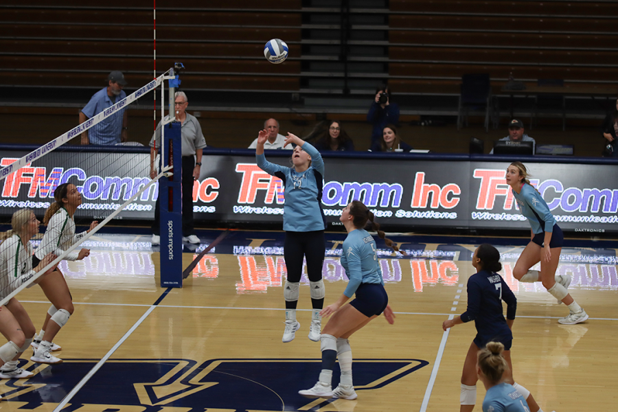 Corinna McMullen (#12) sets up senior Kassidy Pfeiffer (#5) to deliver a piercing hit to the Lions court. McMullen had 17 digs during Washburn’s game against MSSU.