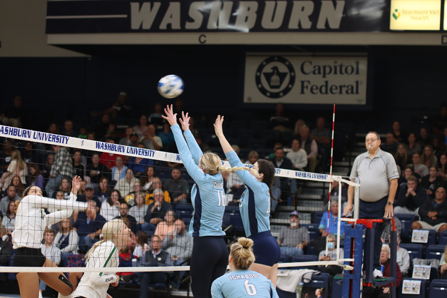 Freshman Austin Broadie (#23) and senior Halle Meister (#16) bound up to block an incoming spike. Broadie is a redshirt this year and had 12 kills during Washburn’s game against the Lions. 