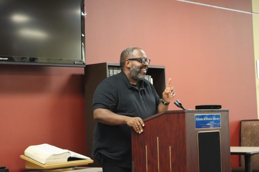 Michael Kleber-Diggs recites his poem from Worldly Things. The reading was held in the Mabee Library on Sept. 23.