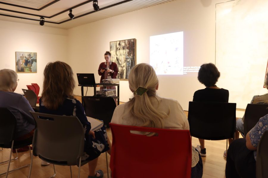 The community gathered at the Mulvane museum to discuss an art piece and what it symbolized—discussing the art stroke, colors, animal imagery and more.