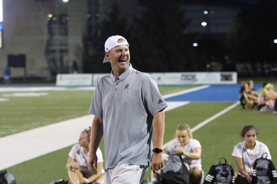 Coach Davy Phillips laughs as he shares a win with his team. His family was in attendance, cheering him on.