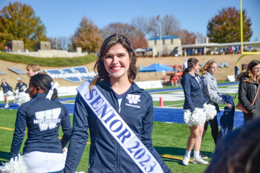 Gracyn Evan, a cheerleader and senior majoring in business finance and marketing, is excited for the last football home game between Washburn University and Pittsburg State University. Washburn cheerleaders, dancers and trumpeters put on their best performance.