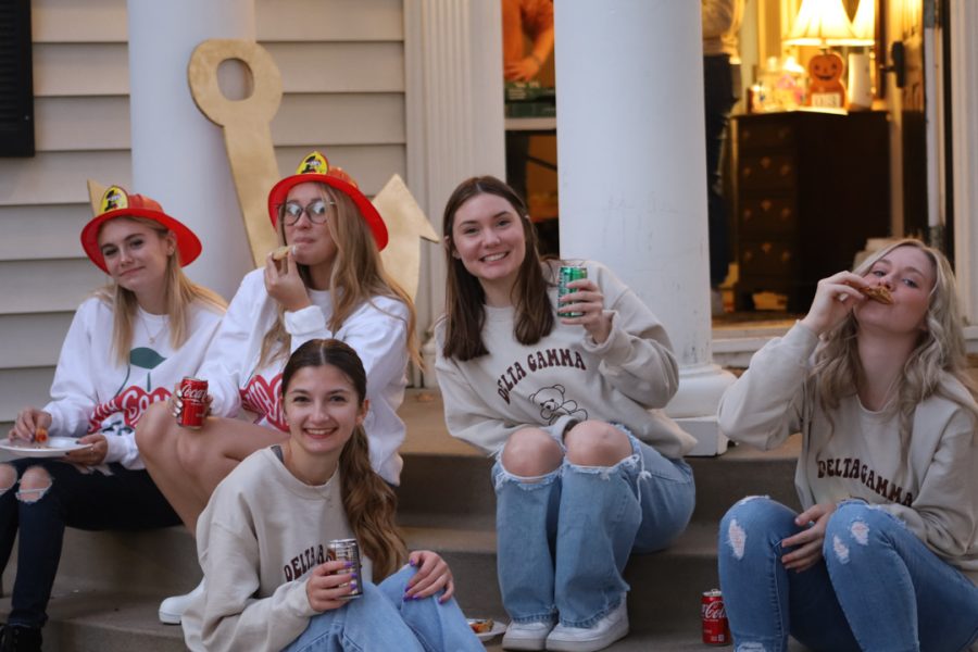 Delta Gamma members Celena Gordon, Katie Hampton, Caidin Meyer, Kennedy Blome and Megan Cushing sit on the steps of the Delta Gamma house. Delta Gamma held their Slices For Sight fundraising event Oct. 28th, 2022.
