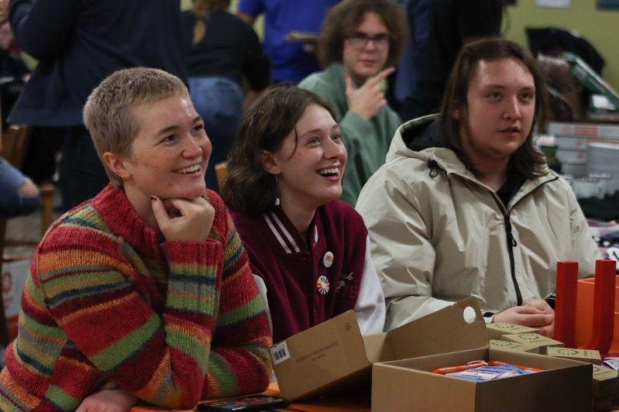 Hannah Whaley, Grace Powers and Hunter Squires, members of Washburn Unite for Reproductive and Gender Equity, greet event attendees. WSGA partnered with URGE to give out free personal supplies to students.