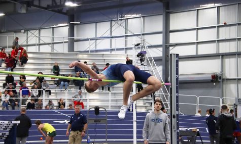 Jordan Dale, freshman high jumper, soars over the bar in the high jump. Dale finished second in the high jump with a top jump of 2.05 meters, breaking the previous meet record of 2.04 meters. Lily Johnson, senior in environmental biology, also broke a meet record in the one mile run with a time of 4:59.17.