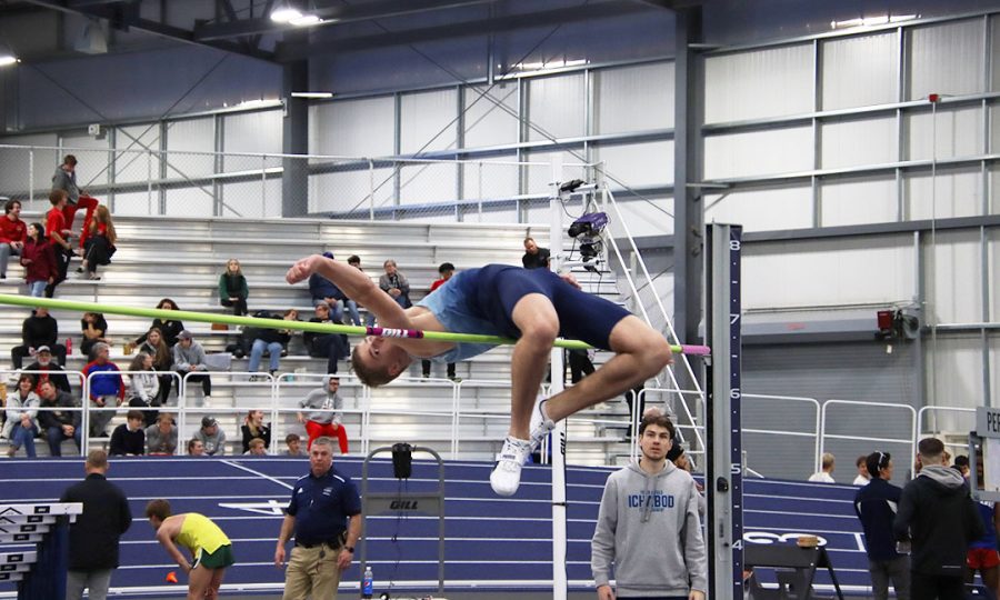 Jordan Dale, freshman high jumper, soars over the bar in the high jump. Dale finished second in the high jump with a top jump of 2.05 meters, breaking the previous meet record of 2.04 meters. Lily Johnson, senior in environmental biology, also broke a meet record in the one mile run with a time of 4:59.17.
