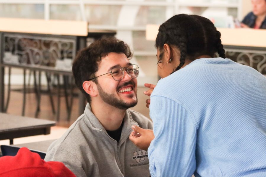 Luiz Alcantara, junior psychology major, gets his makeup done by Elyse Hubbard, freshman forensic investigation major. Kappa Sigma held a fundraiser March 3 where people could pay money to put makeup on its members.