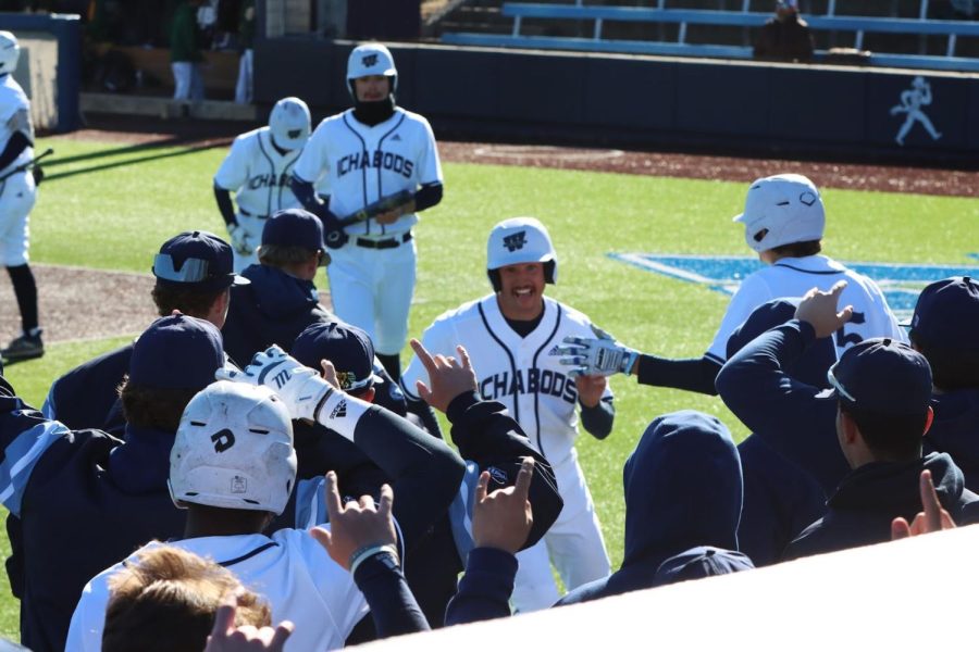 Cal Watkins, junior in integrated studies, cheers with team. Washburn won the game with a score of 10-5.