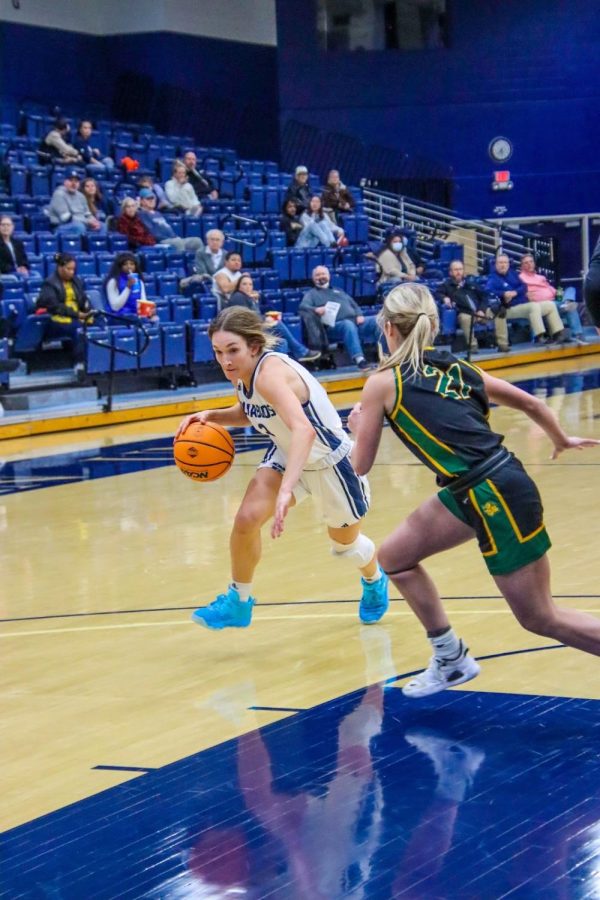 Aubree Dewey, junior, elementary education, driving the ball to the basket. She finished the game as second top scorer and and lead defender with 6 rebounds.